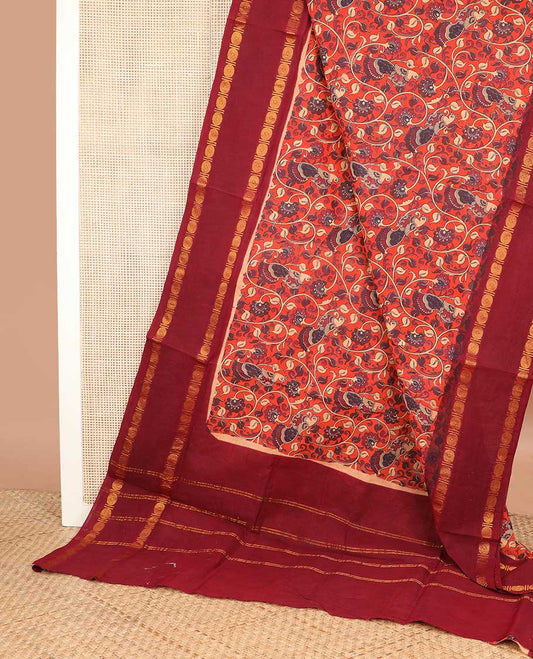 Orange kalamkari style floral vine and bird printed sungudi cotton saree, contrast rettai pettu rudraksham border, and zari striped pallu