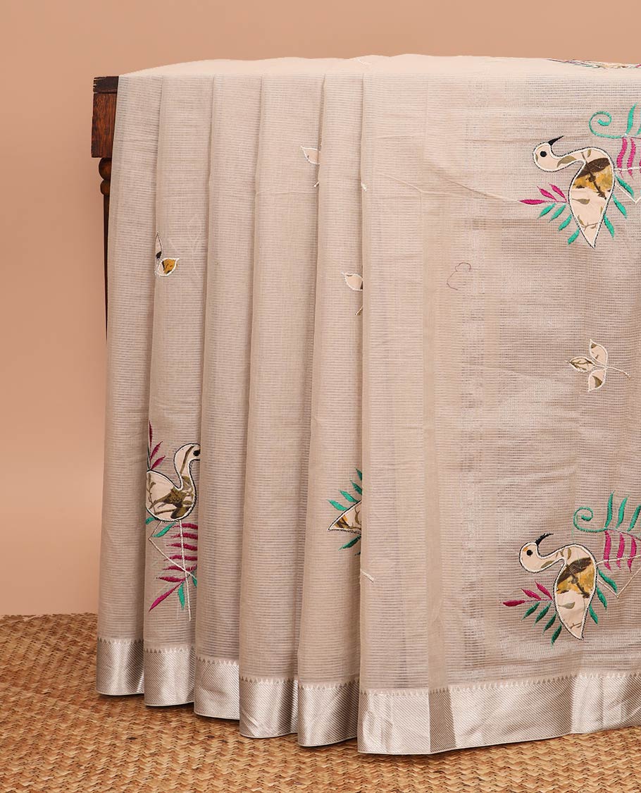 Beige sparsely striped with flamingo patch and thread embroidered chirala cotton saree, temple zari border and pallu of flamingo patch and thread embroidery