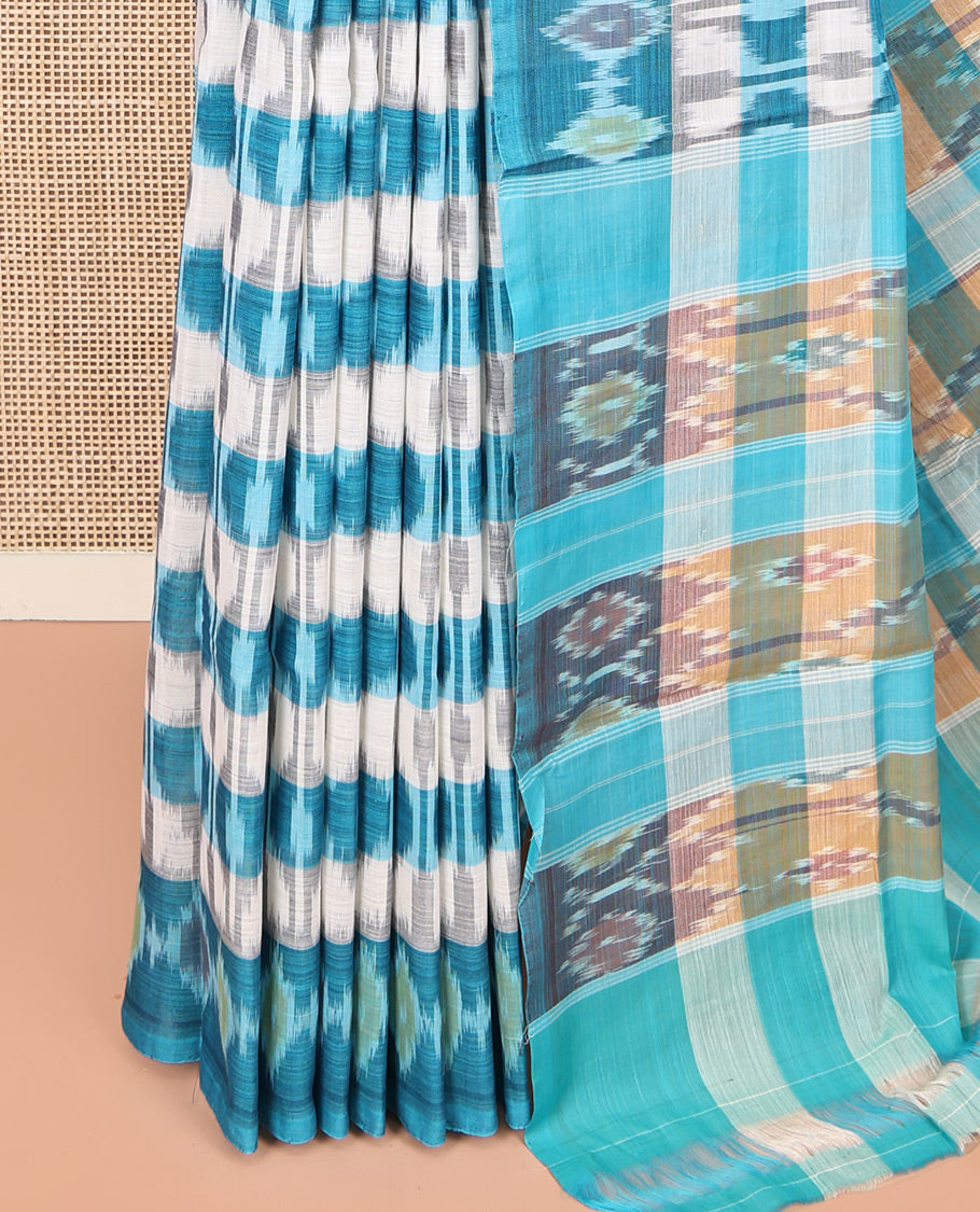 Off-White and Blue Ikkat Cotton Saree, Bedecked with Ikkat Checks All Over Its Body, Subtly Sparkled Ikkat-Textured Border, Ikkat-Textured Pallu, and Has No Blouse