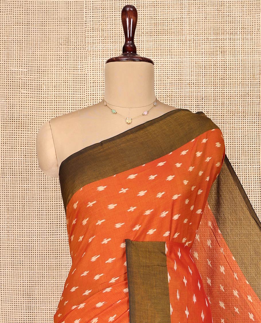 Orange Ikkat Cotton Saree, Accentuated with Ikkat-Style Buttas on Its Body, Complemented by Contrast Ikkat-Textured Border, Pallu Steeped with Ikkat Buttas, and Has No Blouse