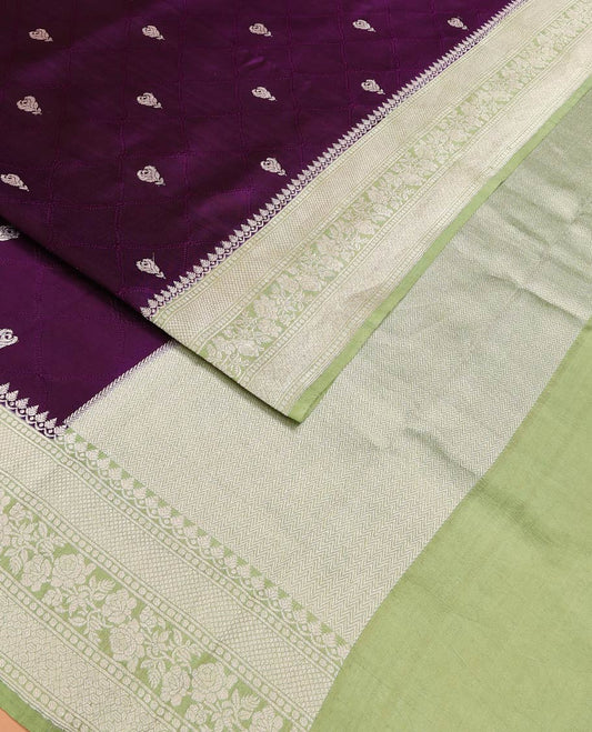 Purple Raw Mango Silk Saree Highlighted by Floral Buttas, Featuring a Contrast Traditional Zari Design Border, a Pallu Elevated with Chevron Stripes, Paired with a Contrast Brocade Blouse