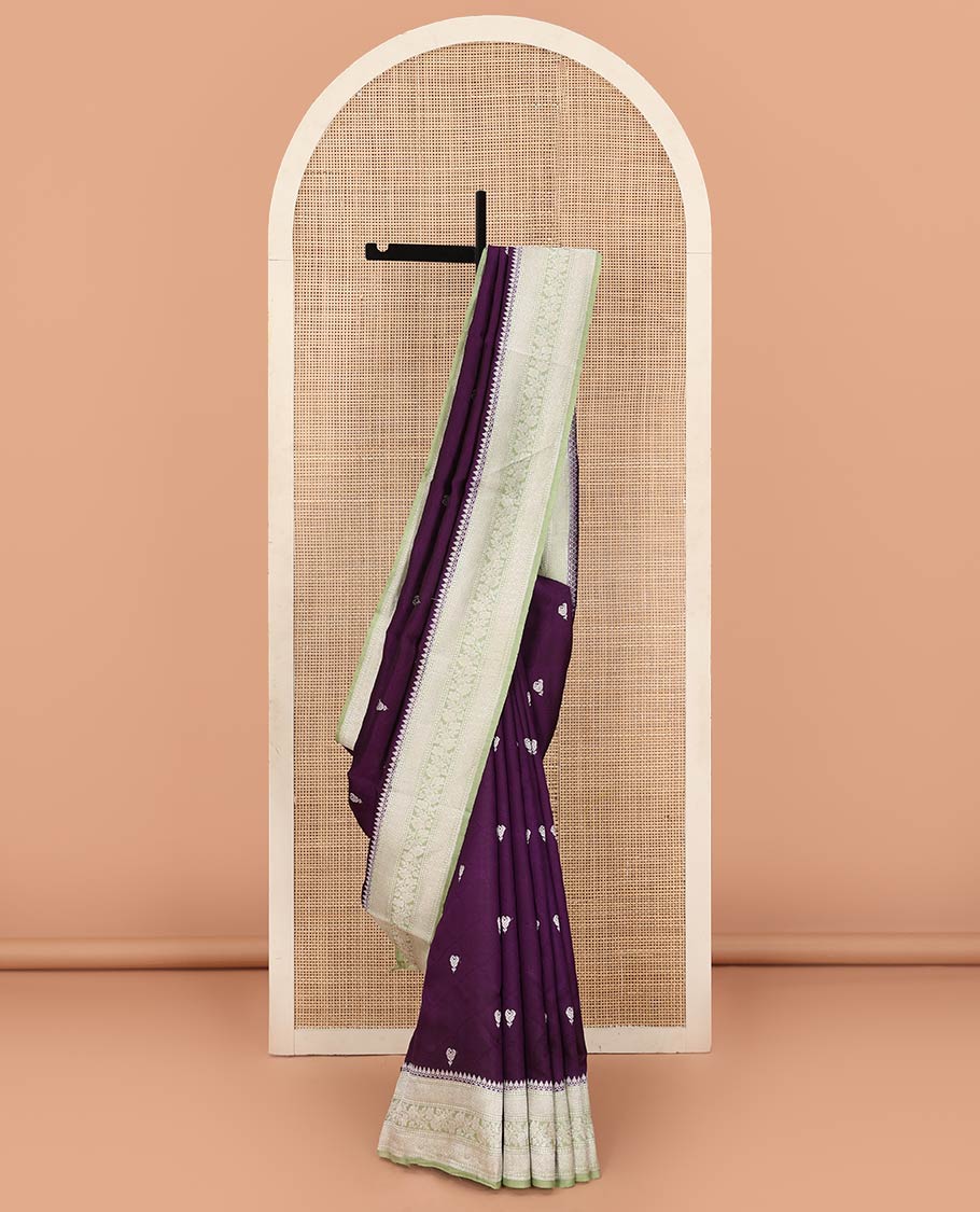 Purple Raw Mango Silk Saree Highlighted by Floral Buttas, Featuring a Contrast Traditional Zari Design Border, a Pallu Elevated with Chevron Stripes, Paired with a Contrast Brocade Blouse