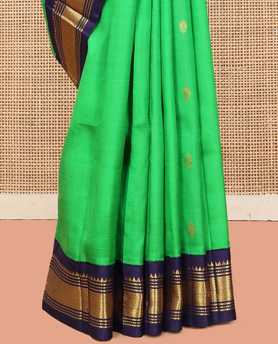 Green Kanchipuram Silk Saree, Accentuated with Zari Buttas, a Contrast One-Sided Korvai Border of Rekku, Banaras, Muthu, and Mayil Kann Designs, a Zari Design Pallu, and No Blouse