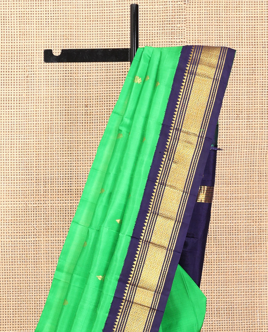 Green Kanchipuram Silk Saree, Accentuated with Zari Buttas, a Contrast One-Sided Korvai Border of Rekku, Banaras, Muthu, and Mayil Kann Designs, a Zari Design Pallu, and No Blouse