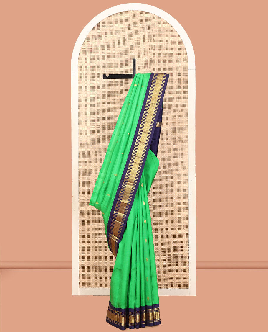 Green Kanchipuram Silk Saree, Accentuated with Zari Buttas, a Contrast One-Sided Korvai Border of Rekku, Banaras, Muthu, and Mayil Kann Designs, a Zari Design Pallu, and No Blouse
