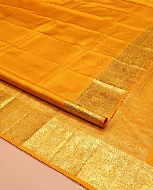 Yellow Kanchipuram Silk Saree, Sparsely Woven with Checked Design All Over Its Body, Highlighted by a Zari Border of Manga, Yaanai, and Mayil Designs, Pallu of Jaal Designs, and Paired with a Matching Blouse