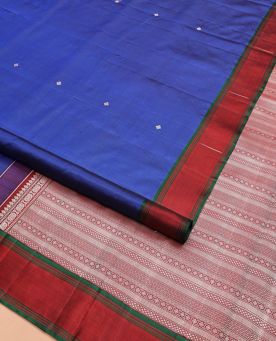 Royal blue buttas Kanchipuram silk saree, contrast border of malli mokku designs, and pallu of geometric designs