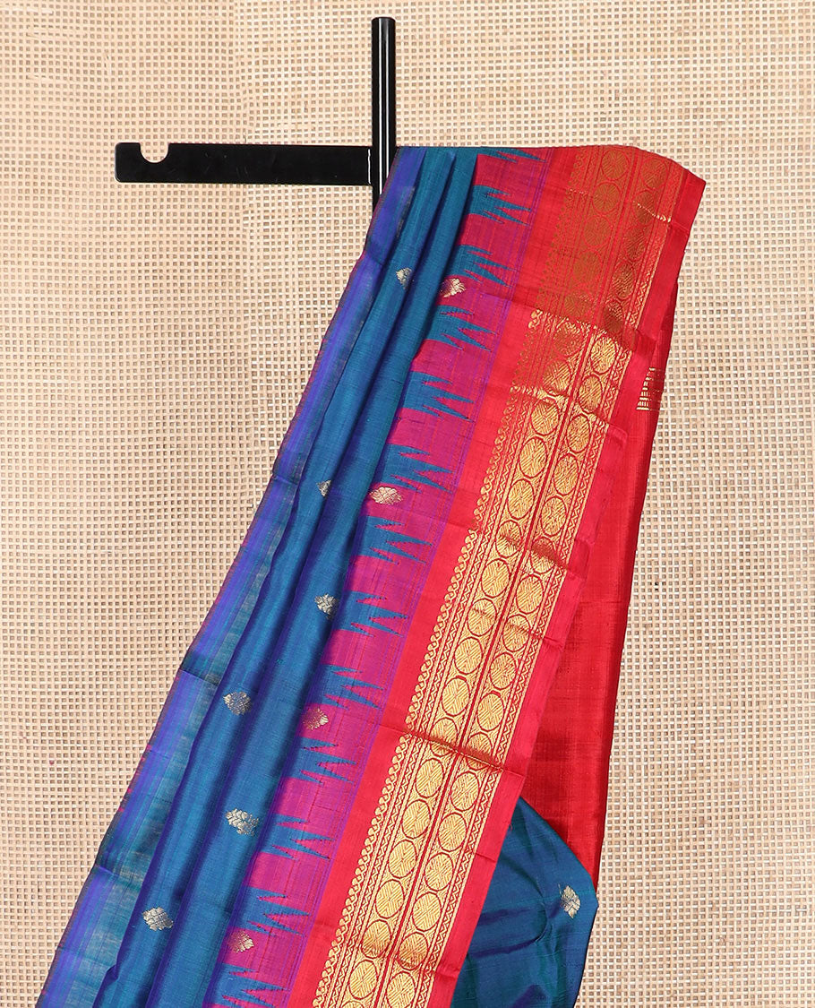 Green Kanchipuram Silk Saree Embellished with Jacquard Design, Highlighted by a Contrast Border of Thilakam, Muthu, Rekku, Manga, Chakram, and Floral Designs, Majestically Woven Pallu Steeped with Chakram Designs, and Paired with a Matching Blouse