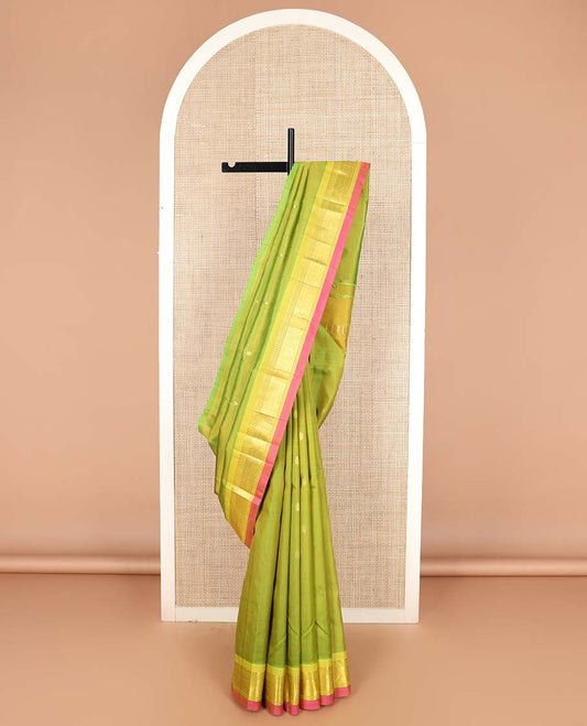 Green zari buttas Kanchipuram silk saree, contrast one-sided border of paneer sombu, banaras, and jaal designs, and zari design pallu