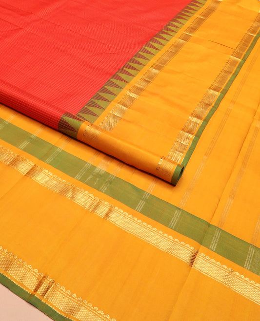Red micro-checked Kanchipuram silk saree, contrast rettai pettu border of thilakam mokku, banaras, and kuyil kann designs, and zari striped pallu