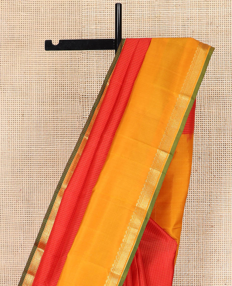 Red micro-checked Kanchipuram silk saree, contrast rettai pettu border of thilakam mokku, banaras, and kuyil kann designs, and zari striped pallu