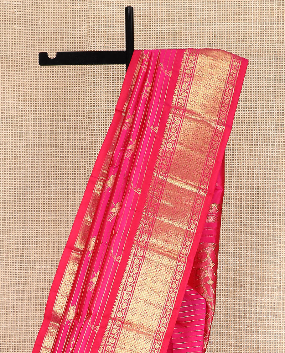 Rani Pink Kanchipuram Silk Saree Graced with Mayil Buttas and Zari Stripes All Over Its Body, Complemented by Contrast One-Sided Border of Kodi Visiry and Jaal Designs, Grandly Woven Pallu of Geometric Patterns, and Comes Without a Blouse