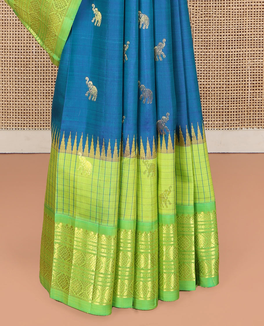 Blue Kanchipuram Silk Saree, Bedecked with Yaanai Buttas, Complemented by Contrast One-Sided Checked Border of Thazanpoo Rekku, Salngai, Banaras, Lavangam, and Laddu Kamalam Designs, Pallu of Floral Designs, and Comes Without a Blouse