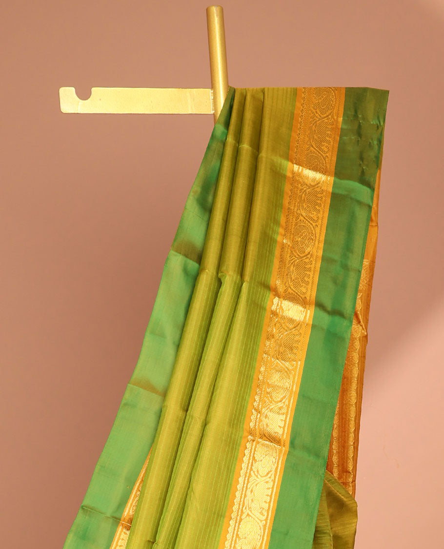 Green kancheepuram silk saree with contrast intricate zari design pallu & striped, round buttas pallu