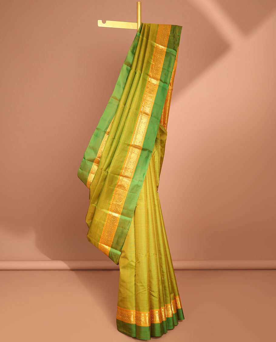 Green kancheepuram silk saree with contrast intricate zari design pallu & striped, round buttas pallu