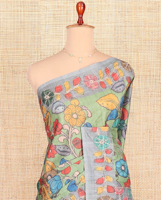 Green Semi-Tussar Saree Elegantly Highlighted with Kalamkari-Style Colorful Floral Print, Complemented by a Contrast Floral Printed Border, Pallu Depicting Krishna and Gopis Print, and Paired with a Matching Printed Blouse