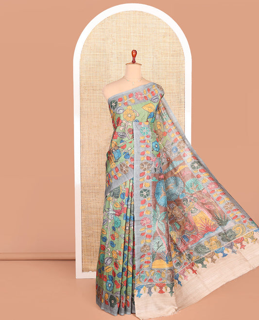 Green Semi-Tussar Saree Elegantly Highlighted with Kalamkari-Style Colorful Floral Print, Complemented by a Contrast Floral Printed Border, Pallu Depicting Krishna and Gopis Print, and Paired with a Matching Printed Blouse