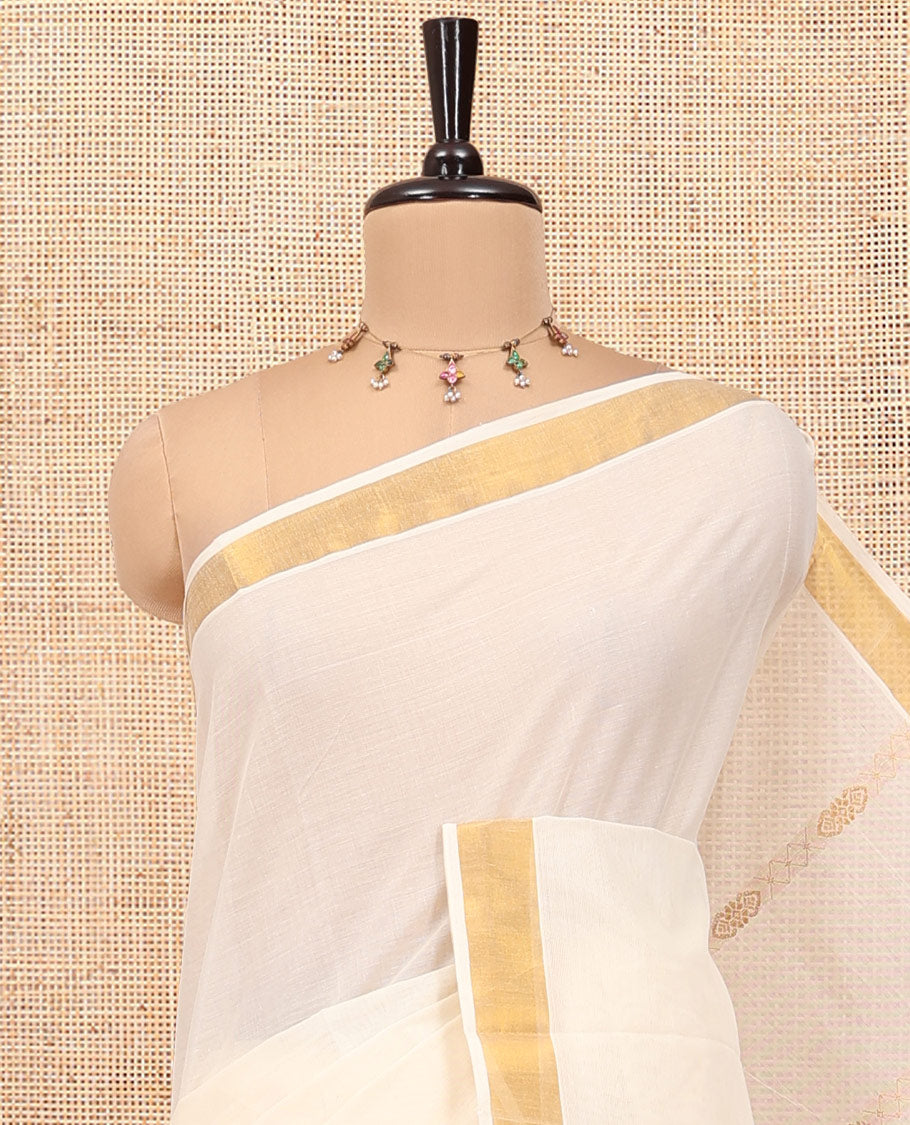 Cream Kerala Cotton Saree, Spotlighted with Zari Stripes All Over Its Body, a Subtle Bavanji Border, Pallu of Intricate Designs, and Is Paired with a Matching Blouse