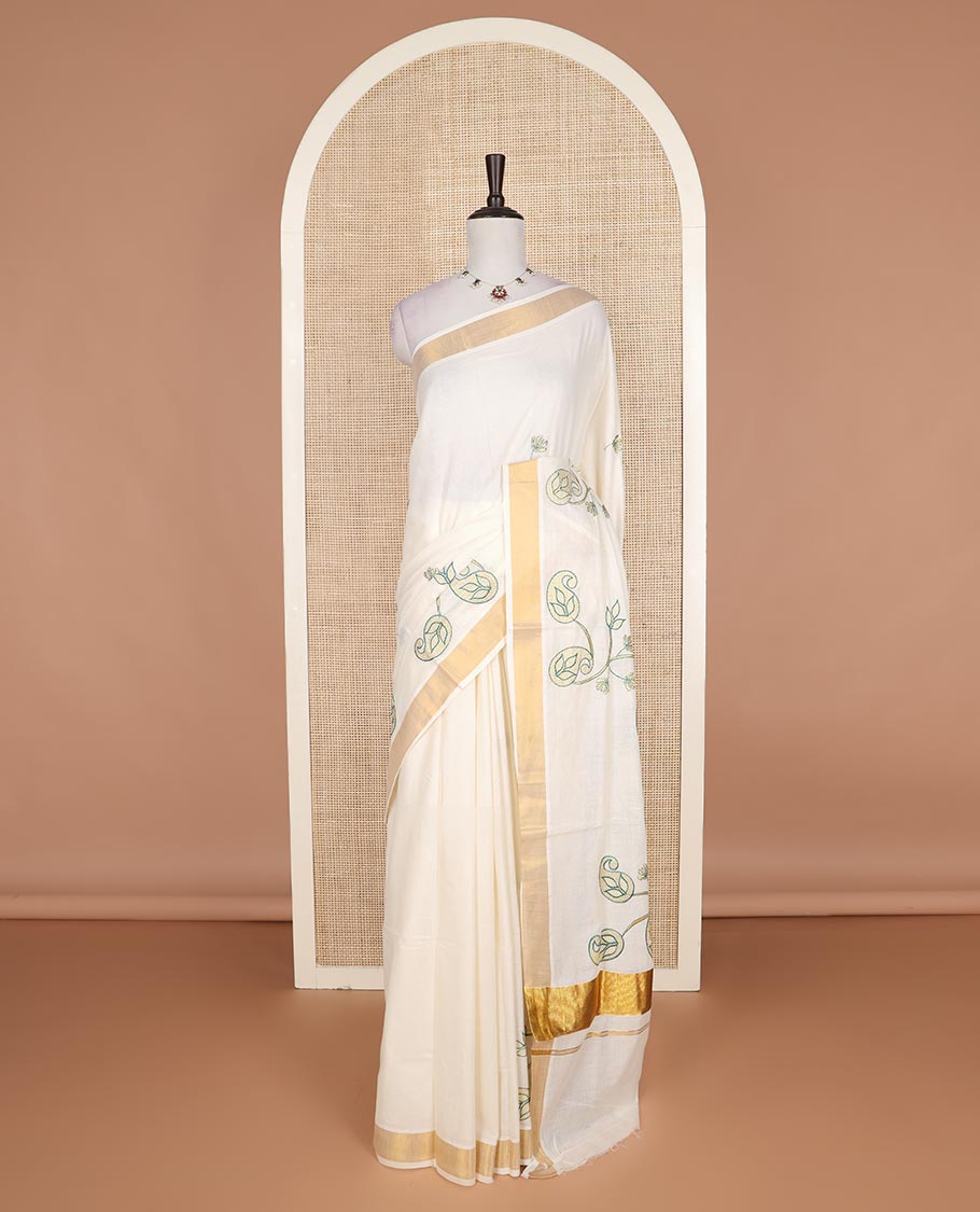 Cream paisley embroidered Kerala cotton saree, zari border, and paisley embroidered pallu
