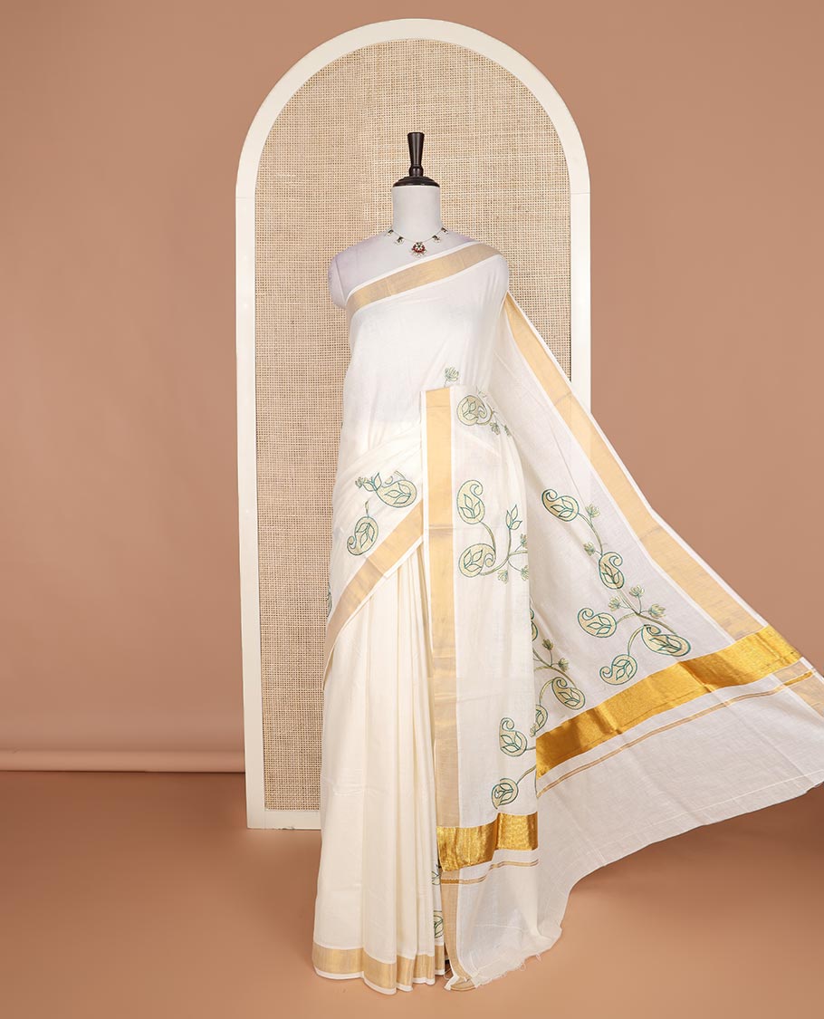 Cream paisley embroidered Kerala cotton saree, zari border, and paisley embroidered pallu