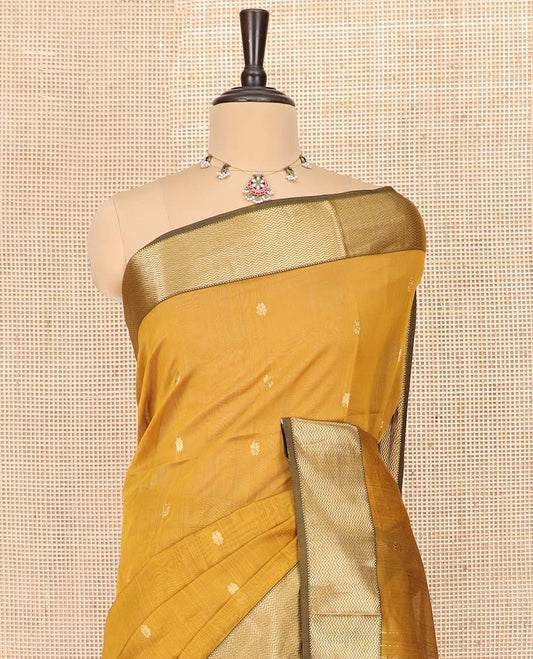 Yellow Maheshwari Cotton Saree Elevated with Floral Buttas, Highlighted with a Chevron Striped Zari Border, Pallu Steeped with Zari Stripes and Chevron Stripes, and Paired with a Matching Blouse