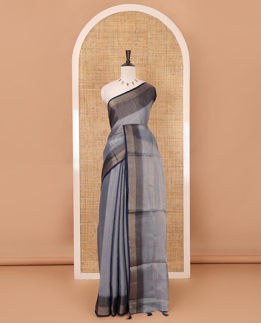 Grey plain tissue saree, contrast gold zari piping border & self pallu with tussels