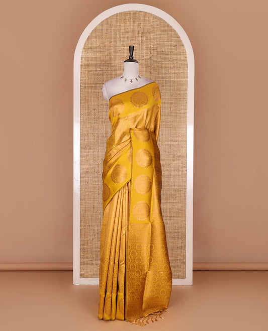 Yellow jacquard kanchi tissue saree, zari chakram motifs border, intricately zari woven pallu, and a matching zari design blouse