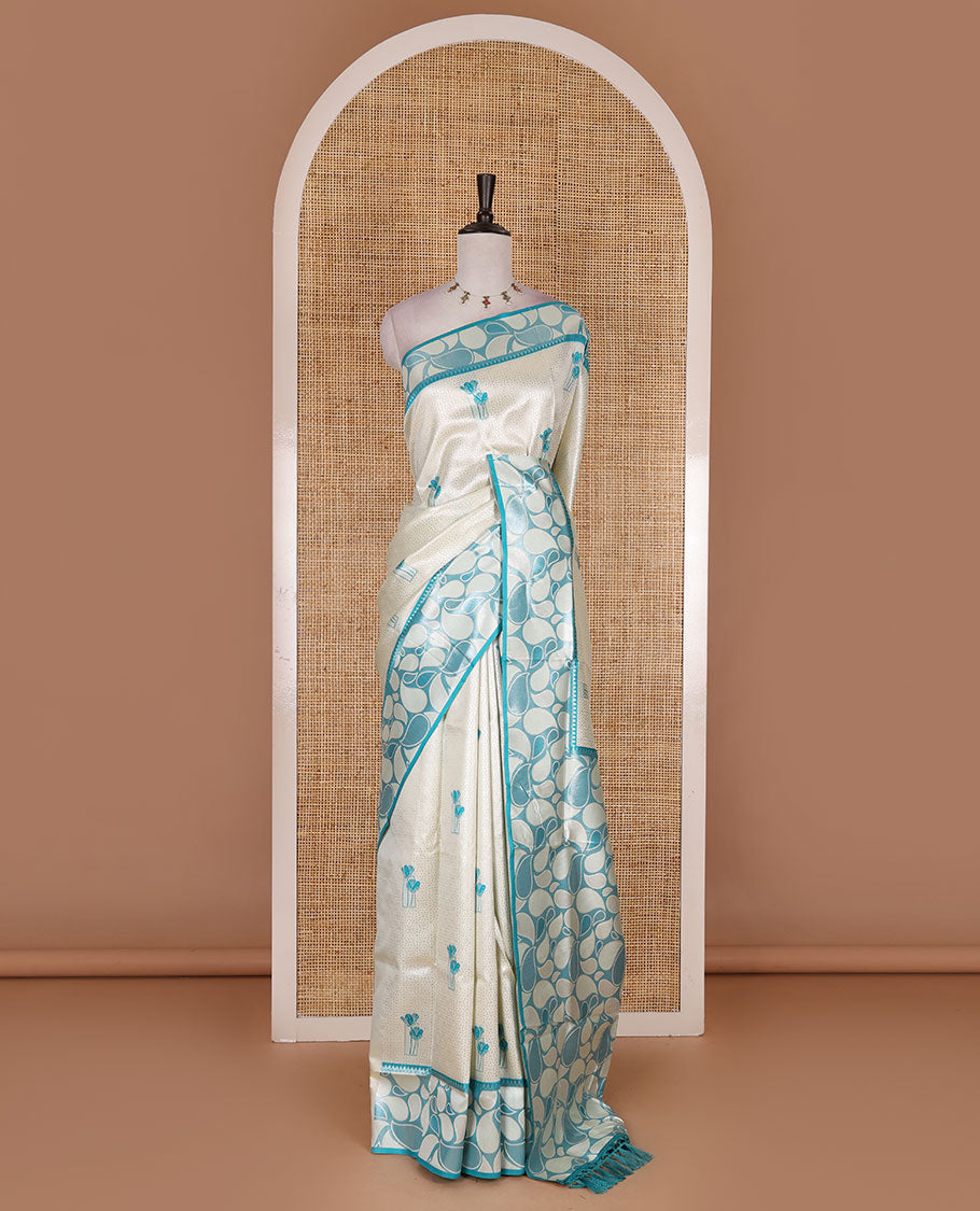 Half-white jacquard kanchi silk saree, contrast border, and pallu steeped with paisley motifs with contrast zari design blouse
