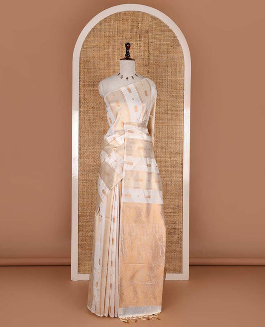 Borderless half-white traditional zari motifs steeped elite soft silk saree, floral jaal pallu, and matching zari buttas woven blouse