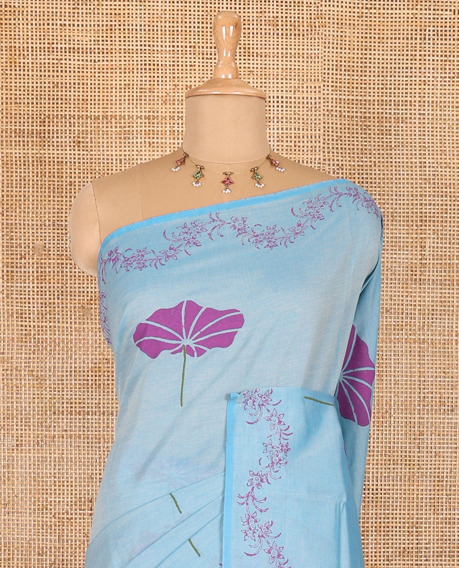 Blue lotus leaf motifs printed South cotton saree with floral creeper border, a matching blouse, and a contrast buttas block printed blouse