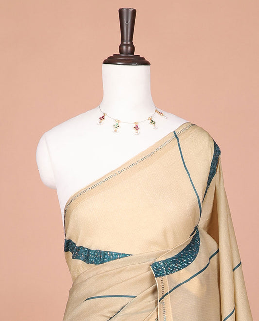 Cream with blue fancy print, swarovski stone work cruncy crush saree, swarovski stone work border & self pallu along with swarovski stone work blouse