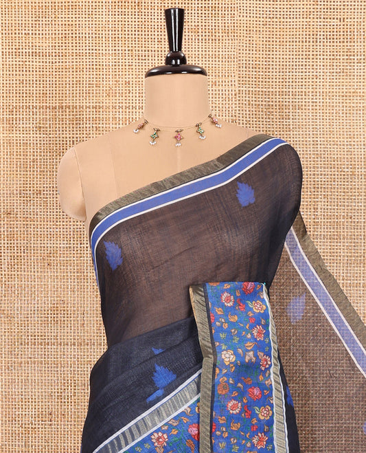 Black Linen Saree Adorned with Leaf Motifs All Over Its Body, Complemented by a Contrast Floral Vine Printed Border, Pallu Mirrors the Floral Vine Print, and Paired with a  Contrast Floral Printed Blouse