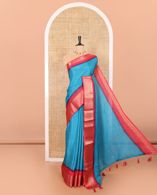 Blue Dola Silk Saree Gleamed up with Vertical Golden Stripes Running All Over Its Body, Complemented by a Contrast Traditional Zari Design Woven Border, Subtly Striped Pallu, and a Contrast Buttas Woven Blouse