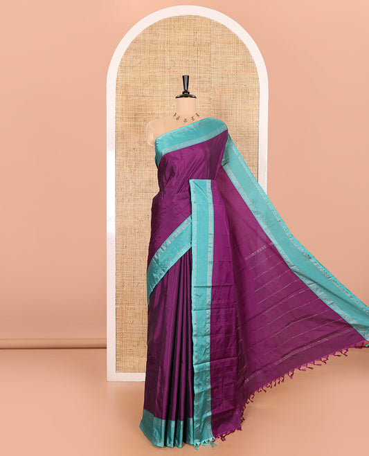 Purple Plain Semi-Soft Silk Saree, Complemented by a Contrast Zari Horizontally Striped Border, Sparsely Striped Pallu, and a Matching Blouse