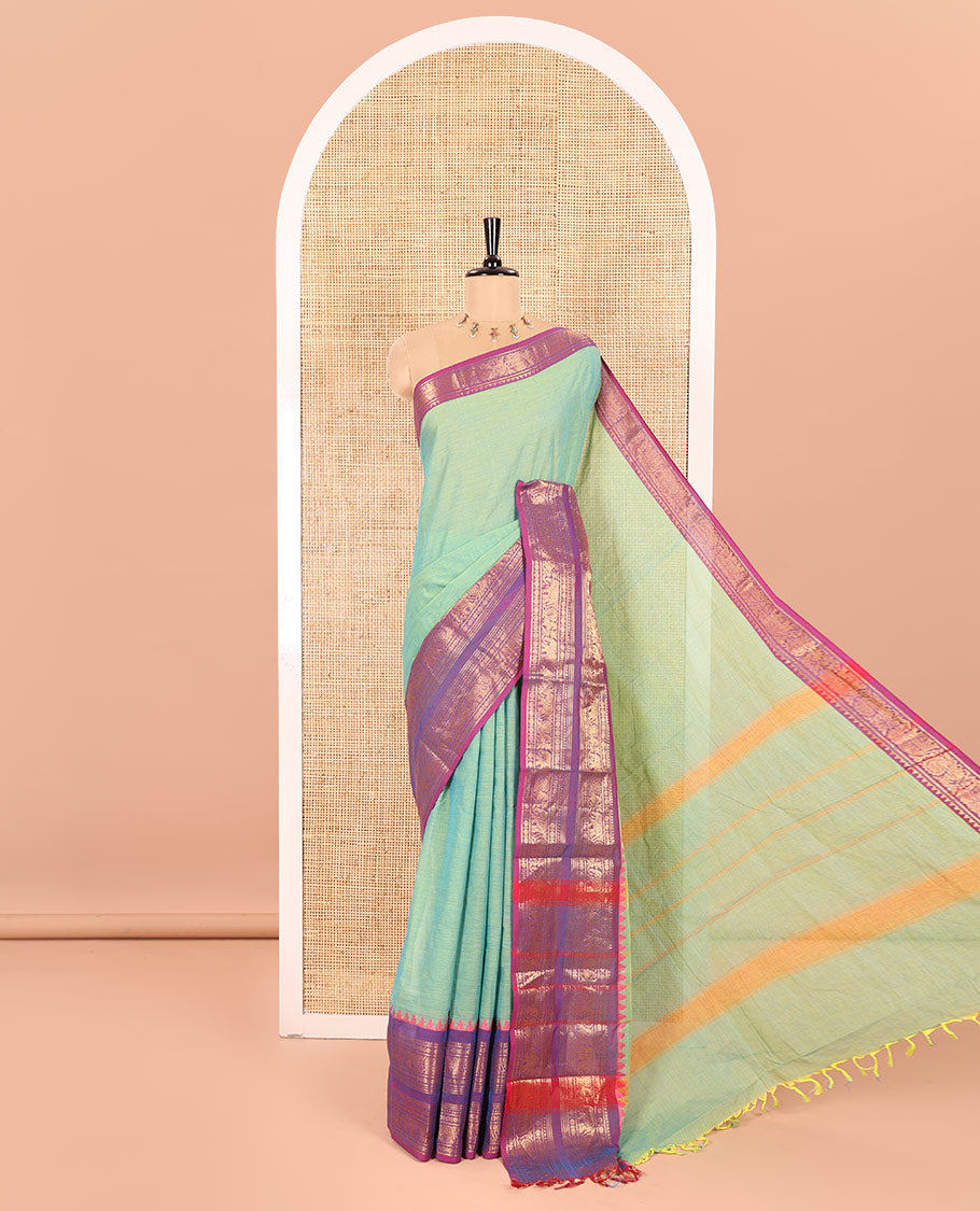Pista Green Plain Chettinad Cotton Saree Decked Up with a Contrasting Temple Rettai Pettu Border of Peacock-Elephant Motifs, a Subtle Pallu of Stripes, and a Matching Blouse