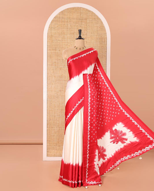 Cream and Red Satin Crepe Saree Adorned with Shibori Prints, Complemented by Contrast Shibori Printed Border, Pallu Decked Up with Shibori Prints, and Paired with a Plain Blouse