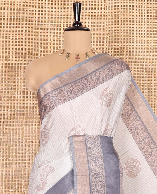 Off-White Katan Silk Saree Enthralled with Stripes and Round Buttas on Its Body, Complemented by a Contrast Border of Floral Creeper Designs, Geometric Patterned Pallu, and Paired with a Contrast Blouse
