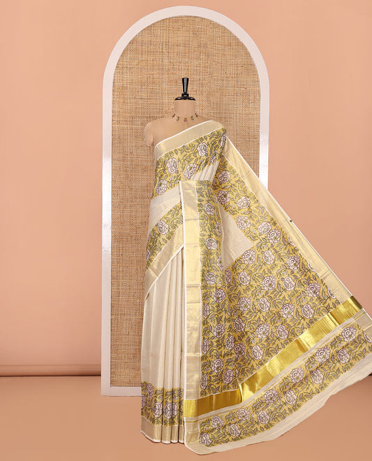 Cream Kerala Tissue Saree, Enriched with Floral Vine Motifs Printed on Its Body, Gleaming Golden Zari Border, Pallu Mirrors the Same Floral Vine Print, and Paired with a Matching Printed Blouse