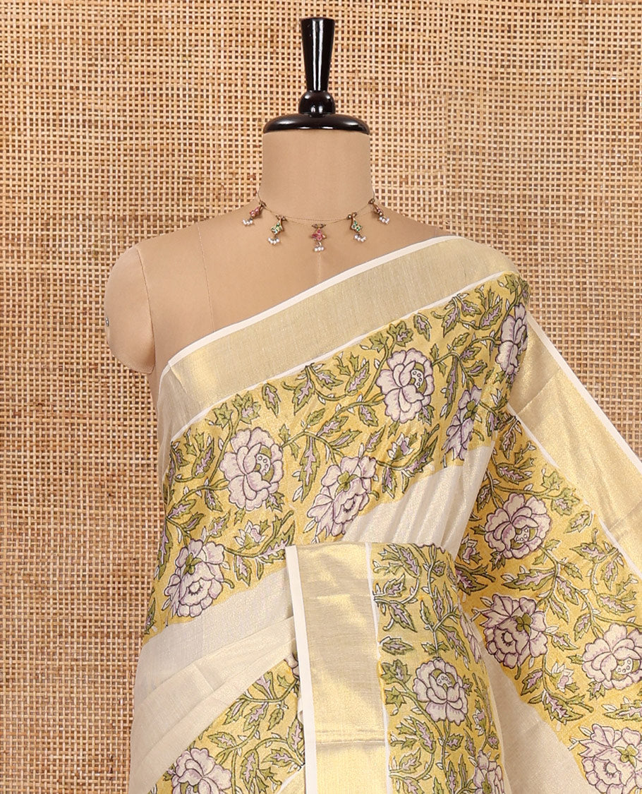 Cream Kerala Tissue Saree, Enriched with Floral Vine Motifs Printed on Its Body, Gleaming Golden Zari Border, Pallu Mirrors the Same Floral Vine Print, and Paired with a Matching Printed Blouse
