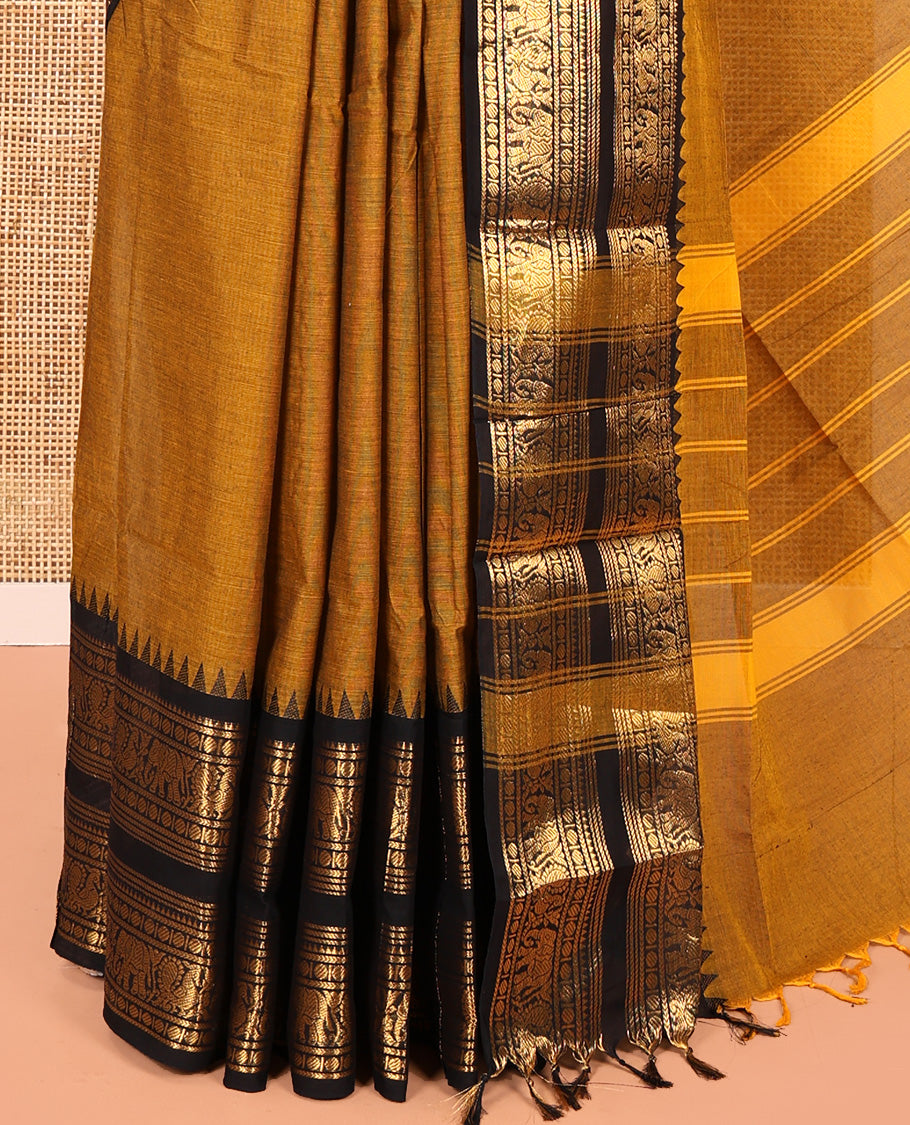 Mustard Plain Chettinad Cotton Saree, Complemented by a Contrast Rettai Pettu Temple Gold Zari Border of Coin, Elephant, and Peacock Designs, Subtly Striped Pallu, and Paired with a Matching Blouse