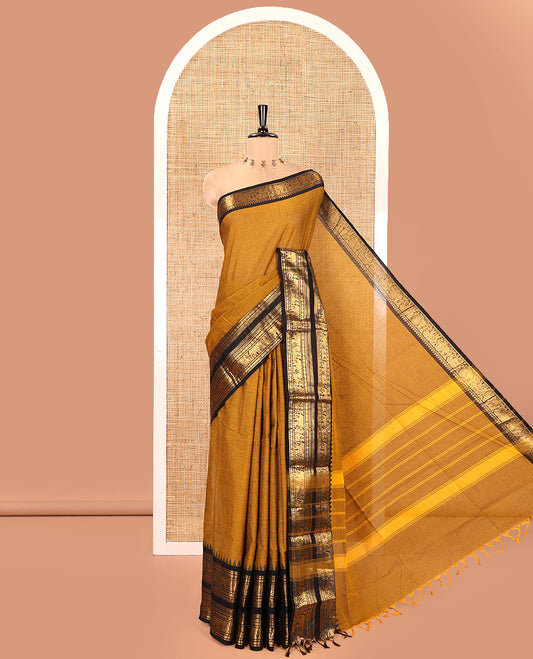 Mustard Plain Chettinad Cotton Saree, Complemented by a Contrast Rettai Pettu Temple Gold Zari Border of Coin, Elephant, and Peacock Designs, Subtly Striped Pallu, and Paired with a Matching Blouse