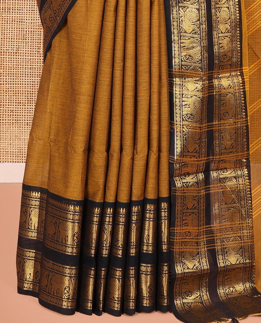 Mustard Plain Chettinad Cotton Saree, Complemented by a Contrast Rettai Pettu Zari Border of Thilakam Mokku, Rudraksham, Elephant, and Peacock Designs, Subtly Striped Pallu, and Paired with a Matching Blouse
