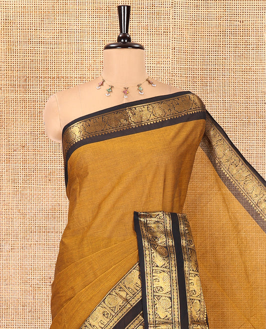 Mustard Plain Chettinad Cotton Saree, Complemented by a Contrast Rettai Pettu Zari Border of Thilakam Mokku, Rudraksham, Elephant, and Peacock Designs, Subtly Striped Pallu, and Paired with a Matching Blouse