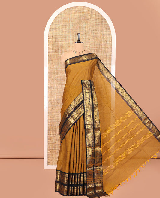 Mustard Plain Chettinad Cotton Saree, Complemented by a Contrast Rettai Pettu Zari Border of Thilakam Mokku, Rudraksham, Elephant, and Peacock Designs, Subtly Striped Pallu, and Paired with a Matching Blouse