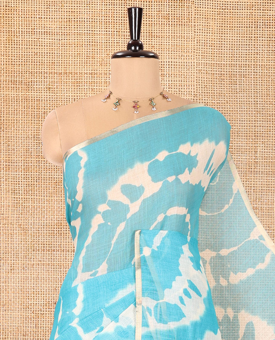 Borderless Blue Linen Cotton Saree, Bedecked with Shibori Printed on Its Body, Complemented by Contrast Floral Printed Pallu, and Paired with a Contrast Floral Printed Blouse