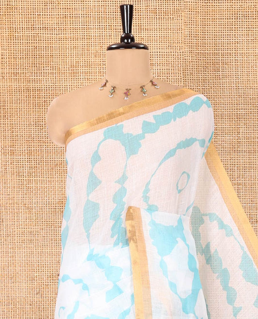 White-Green Linen Cotton Saree, Elevated with Shibori-Printed Body, Highlighted by Piping Border, Floral Printed Pallu, and a Contrast Blouse