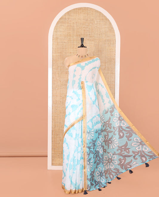 White-Green Linen Cotton Saree, Elevated with Shibori-Printed Body, Highlighted by Piping Border, Floral Printed Pallu, and a Contrast Blouse
