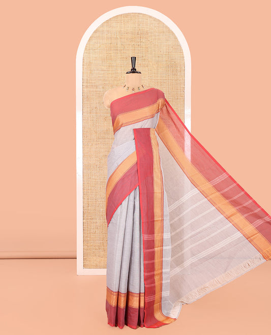 Grey Plain Chettinad Cotton Saree, Complemented by a Contrast Kal Eragina Traditional Temple Border, Subtly Striped Pallu, and Paired with a Matching Blouse