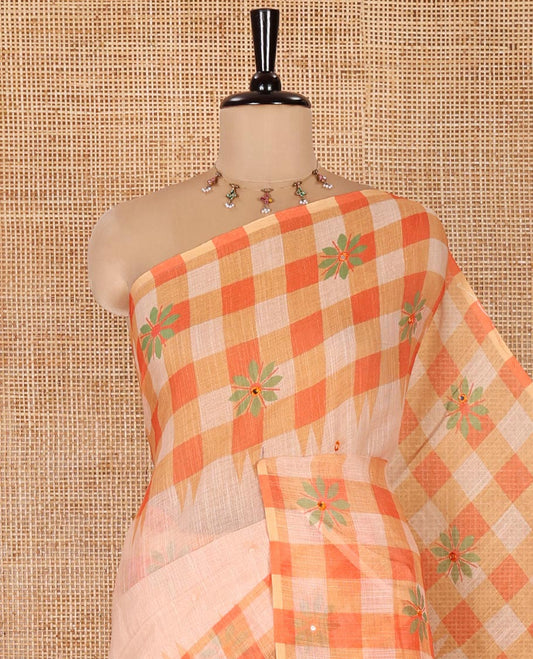 Chikku and Orange Linen Cotton Saree, Elevated with Mirror Work On Its Body, Complemented by Contrast Temple Checked Border of Floral Print and Mirror Work, Pallu Mirrors the Same Design and Paired with a Contrast Blouse