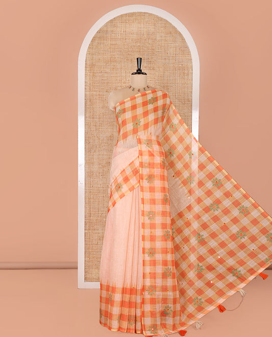 Chikku and Orange Linen Cotton Saree, Elevated with Mirror Work On Its Body, Complemented by Contrast Temple Checked Border of Floral Print and Mirror Work, Pallu Mirrors the Same Design and Paired with a Contrast Blouse